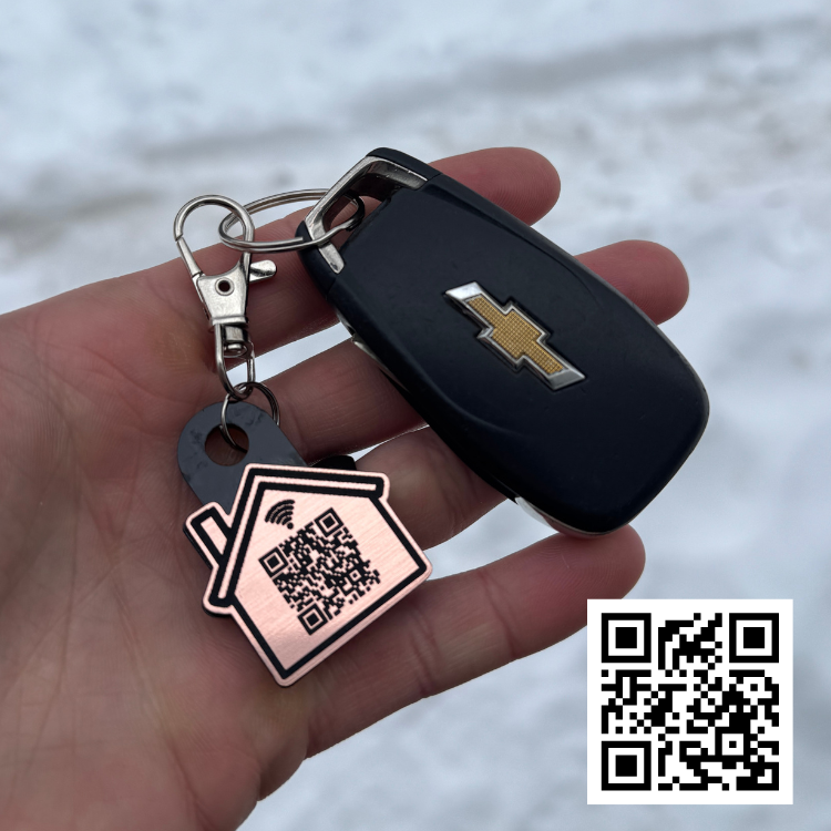 Custom NFC realtor keychain with house-shaped QR code design attached to car keys, tap-to-share contact info and listings for real estate agents